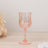 Pink crystal wine glass with a diamond pattern and elegant stem.