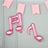 Pink musical note balloons hanging with decorative pink banners.