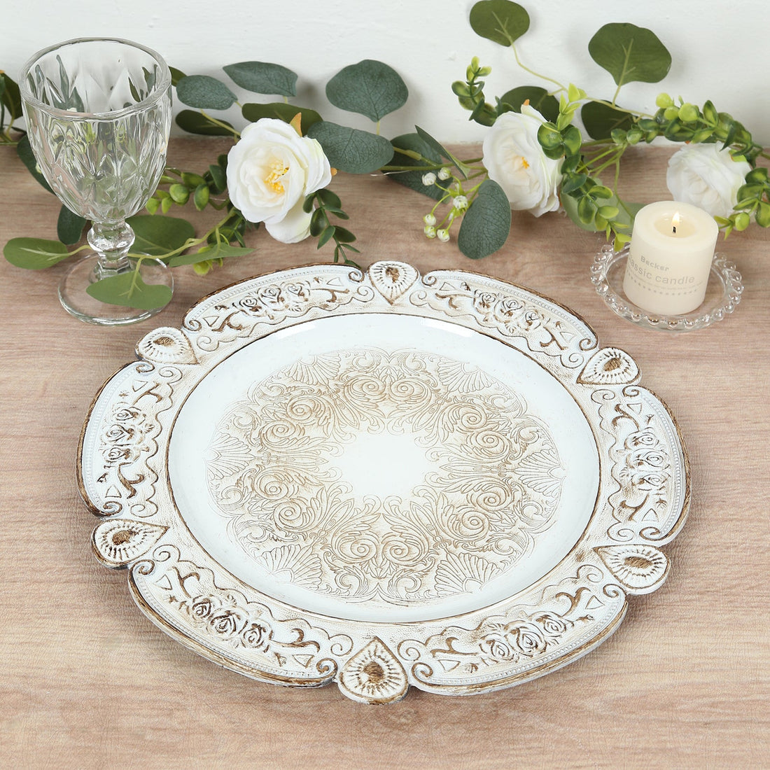 Decorative white plate with intricate floral design on a wooden table