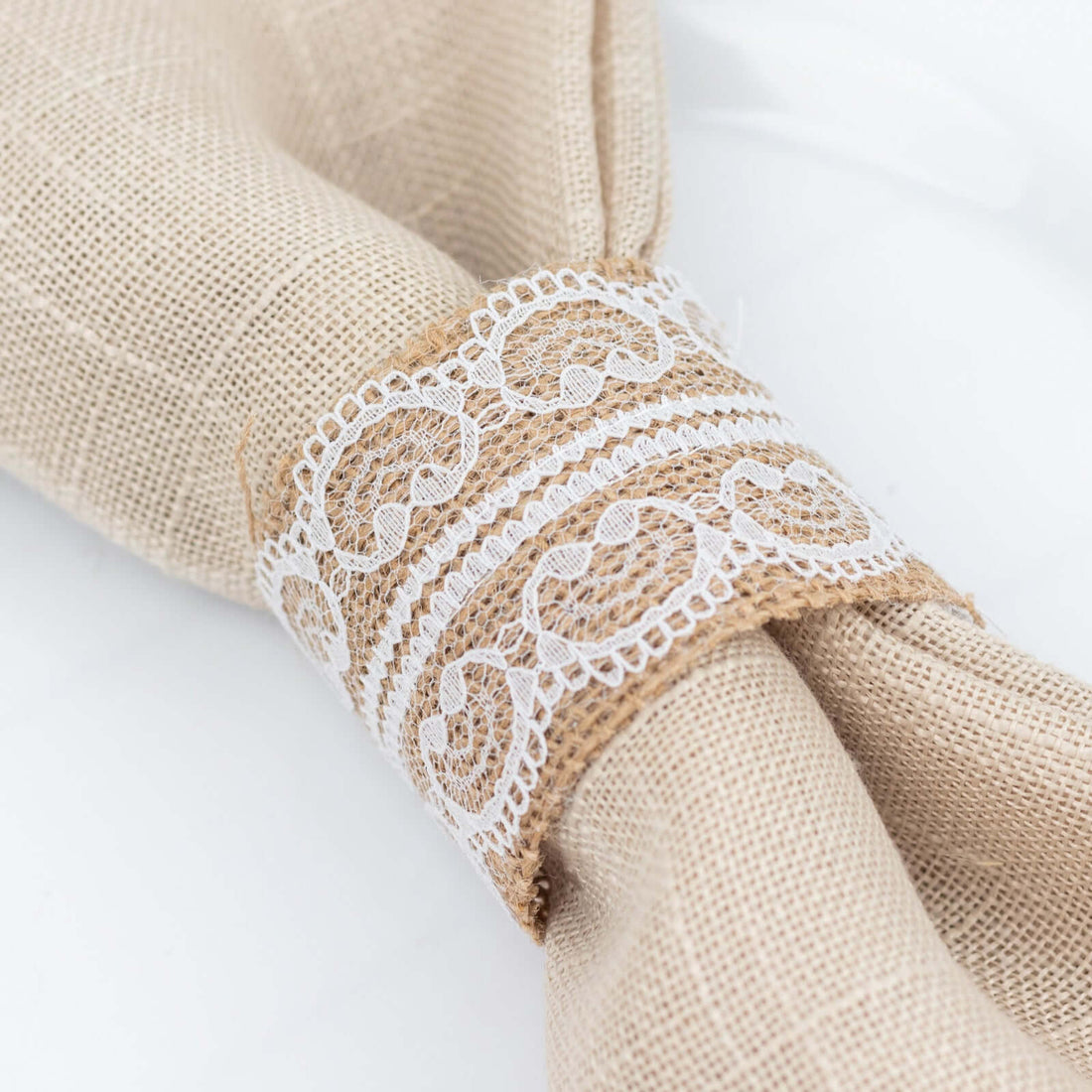 Linen napkin with lace trim on a white background