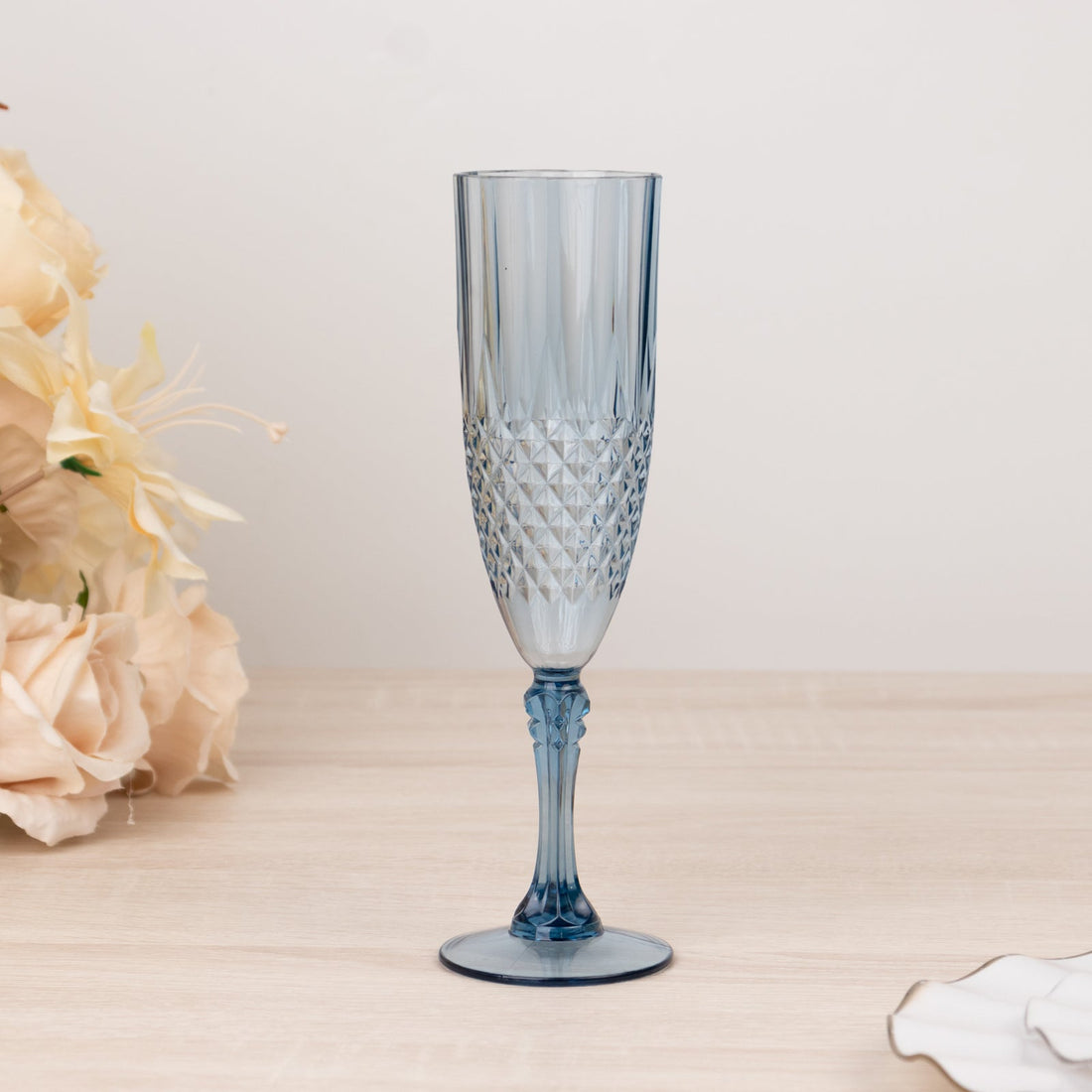 Blue crystal champagne flute with a textured design.