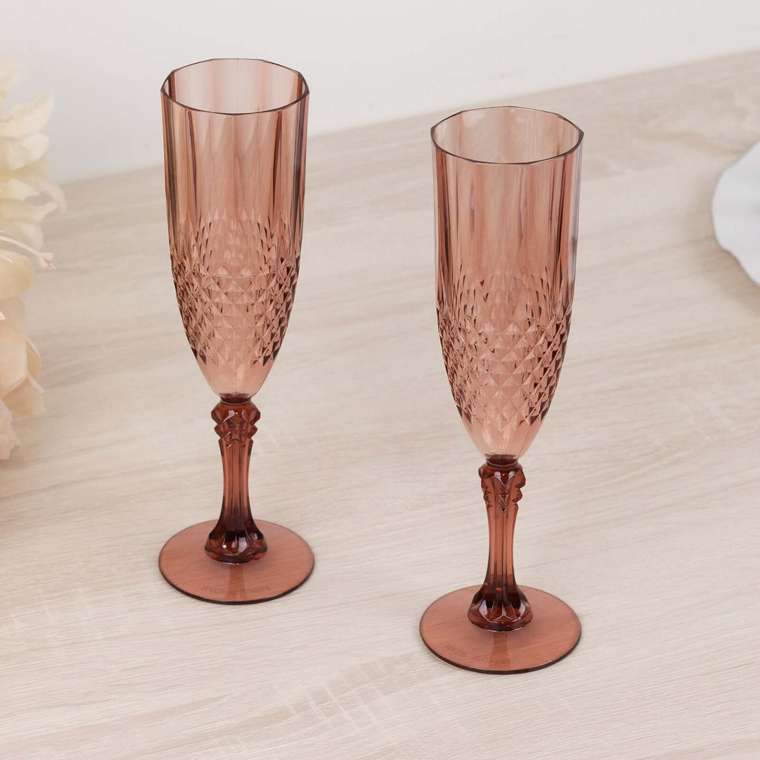 Elegant pink champagne flutes in a stylish design.