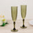 Green glass champagne flutes with diamond pattern design.