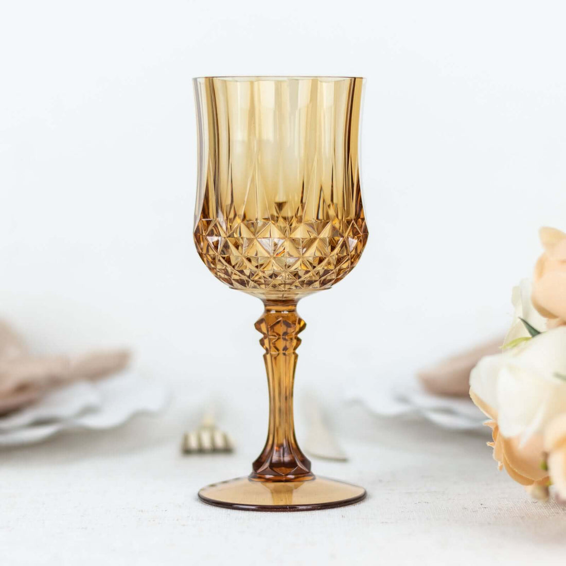 Amber crystal goblet with intricate design, perfect for elegant dining.