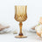 Amber crystal goblet with intricate design, perfect for elegant dining.