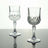 Crystal wine glasses with intricate cut designs, reflecting light elegantly.