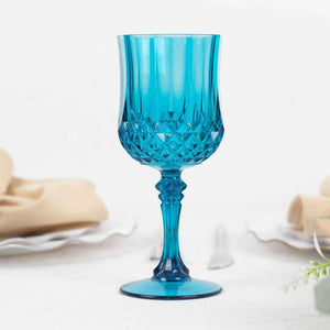 Blue crystal wine glass with a diamond pattern on a white background