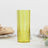 Yellow textured glass tumbler on a white background