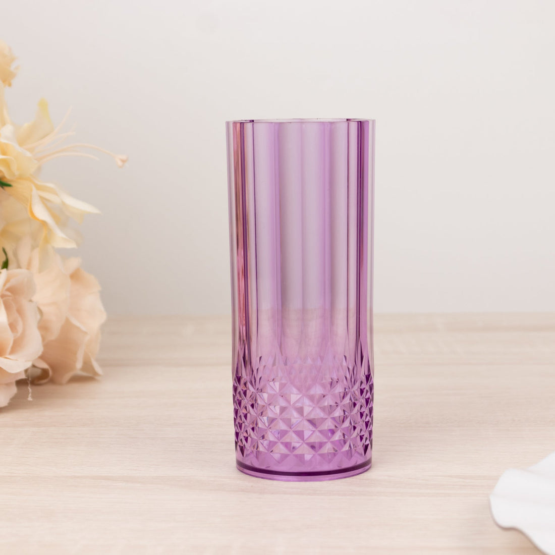 Purple textured glass tumbler on a wooden surface.