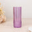 Purple textured glass tumbler on a wooden surface.