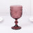 Vintage pink glass goblet with intricate design and pedestal base