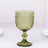 Green decorative glass goblet with intricate detailing.