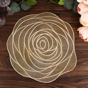 Gold rose-shaped decorative plate on a wooden table.