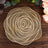 Gold rose-shaped decorative plate on a wooden table.