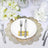 Elegant table setting with gold lace placemat, white plate, and silver cutlery.