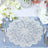 Lace table doily on a blue tablecloth with floral decorations