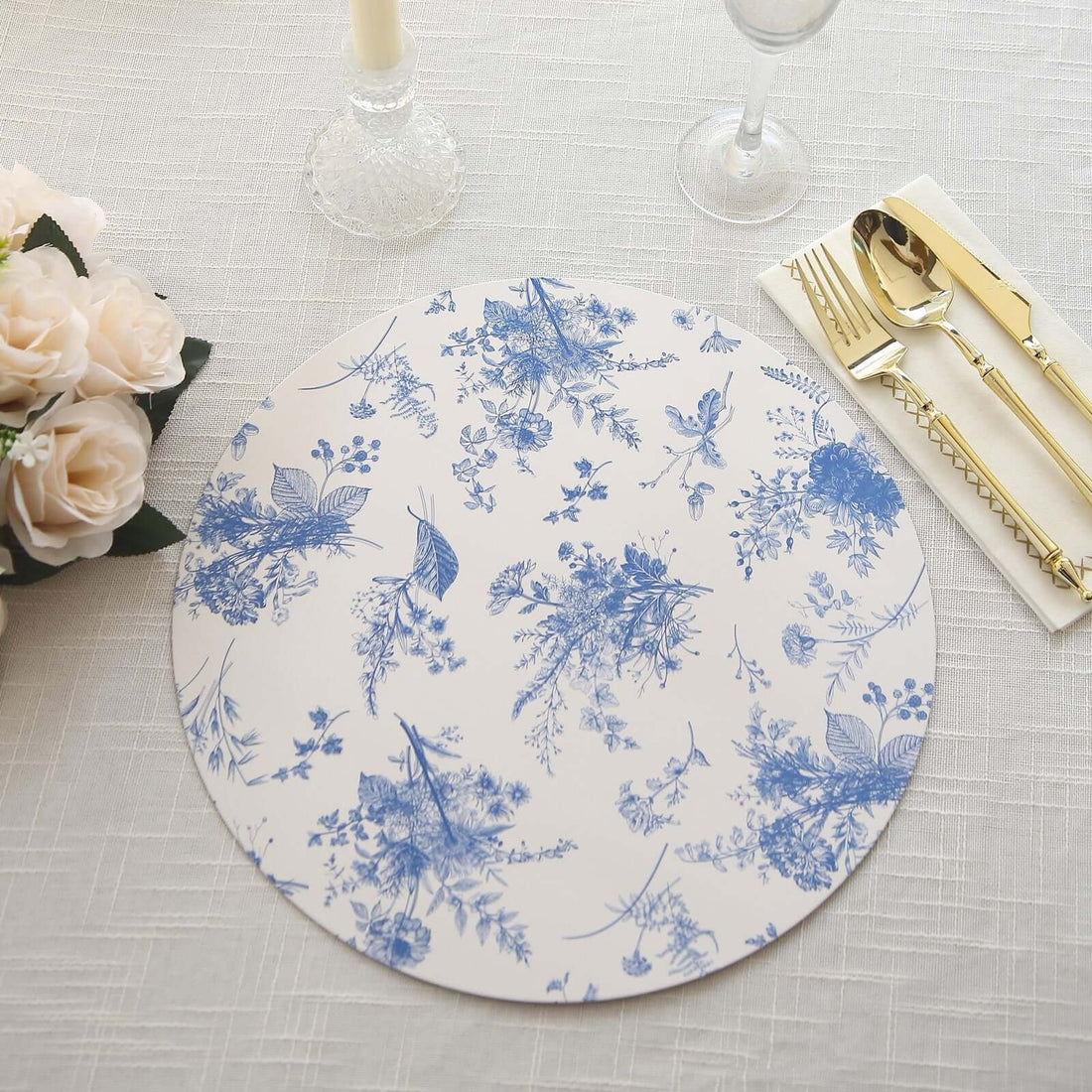 Floral blue and white round placemat on a textured table setting.