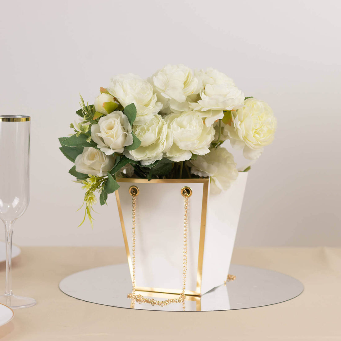 Elegant white flower arrangement in a gold-accented vase.