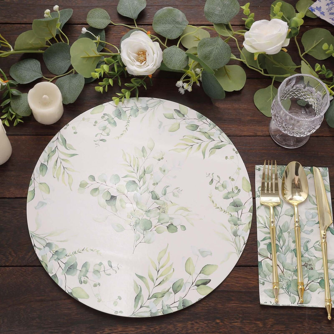 Elegant floral dinner plate with greenery design, set on a wooden table.