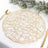 Gold decorative table placemat with intricate design.