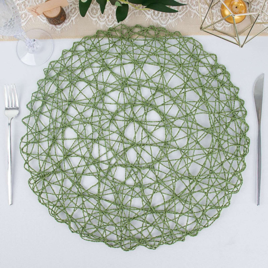 Green woven placemat in a circular design on a dining table.