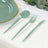 Mint green cutlery set with spoon, fork, and knife on a textured tablecloth.