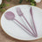 Purple plastic cutlery set on a white plate