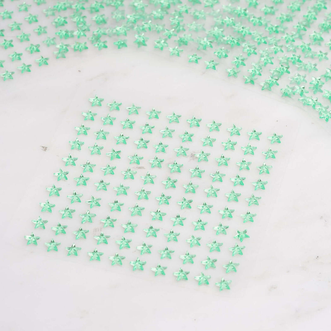 Green star-shaped embellishments arranged in a grid pattern.