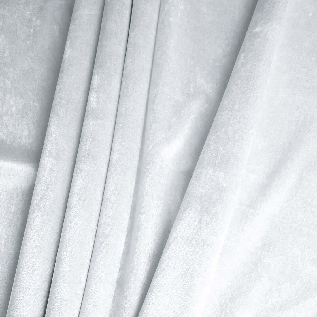 Textured light gray fabric draped elegantly in soft folds.