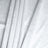 Textured light gray fabric draped elegantly in soft folds.