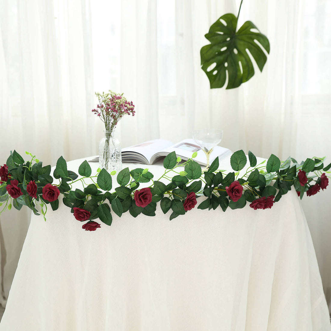 Rose and greenery table garland for events and decorations.