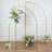 Gold metal arch with floral arrangements for events or decor.