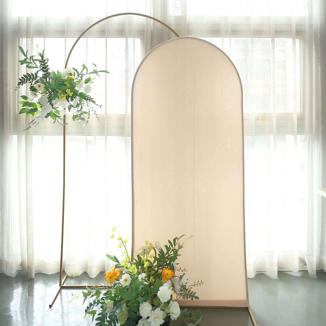 Elegant flower display with a decorative backdrop in natural light.