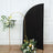 Black curved backdrop with floral arrangement in a gold stand.