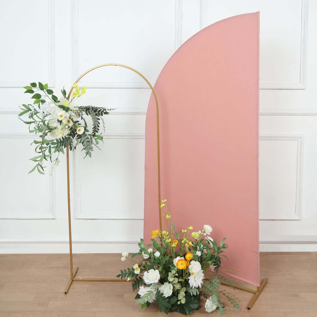 Floral arrangement with arch backdrop in a studio setting