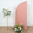 Floral arrangement with arch backdrop in a studio setting