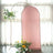 Pink backdrop with floral arrangement in studio setting.