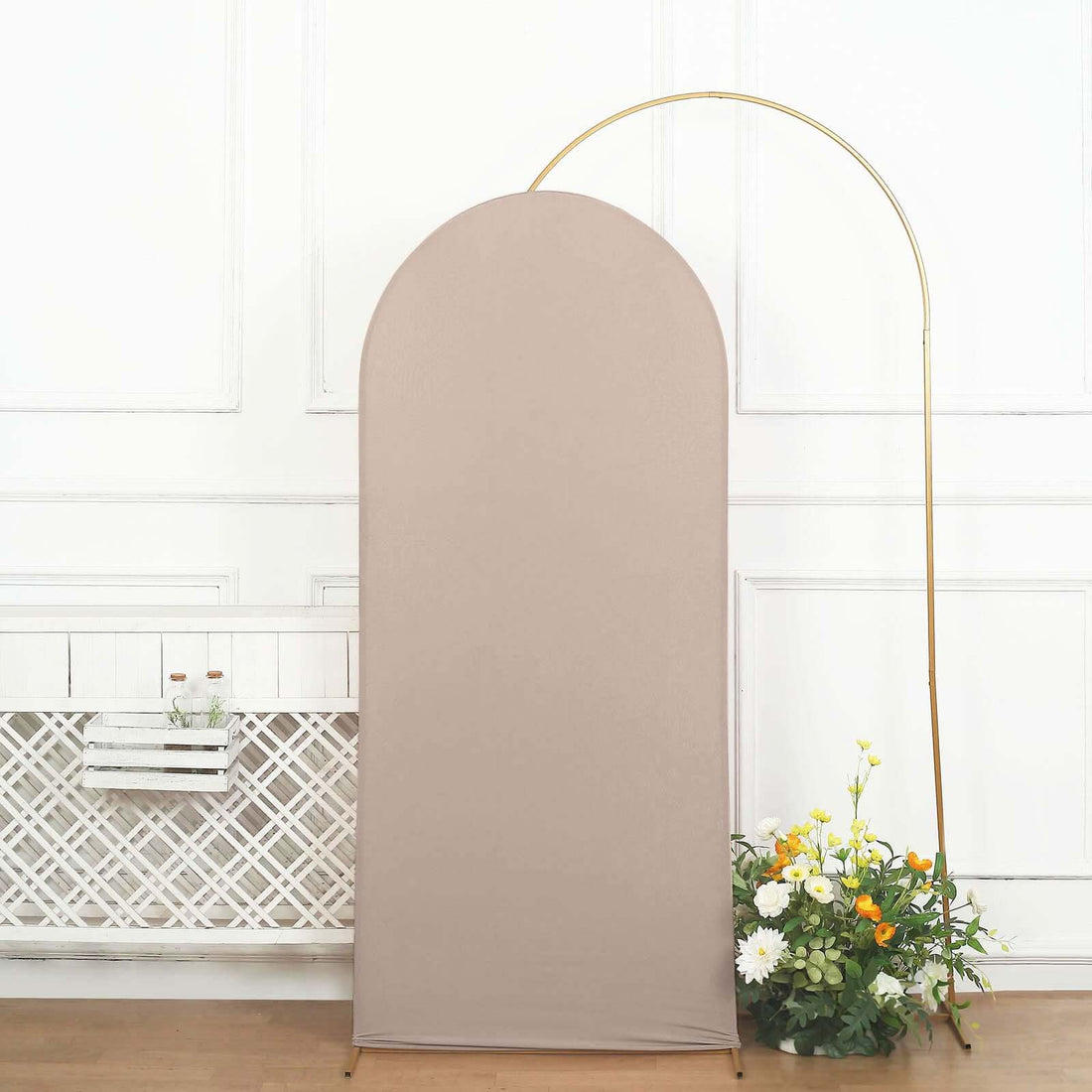Beige fabric backdrop with curved top and gold arch, adorned with flowers