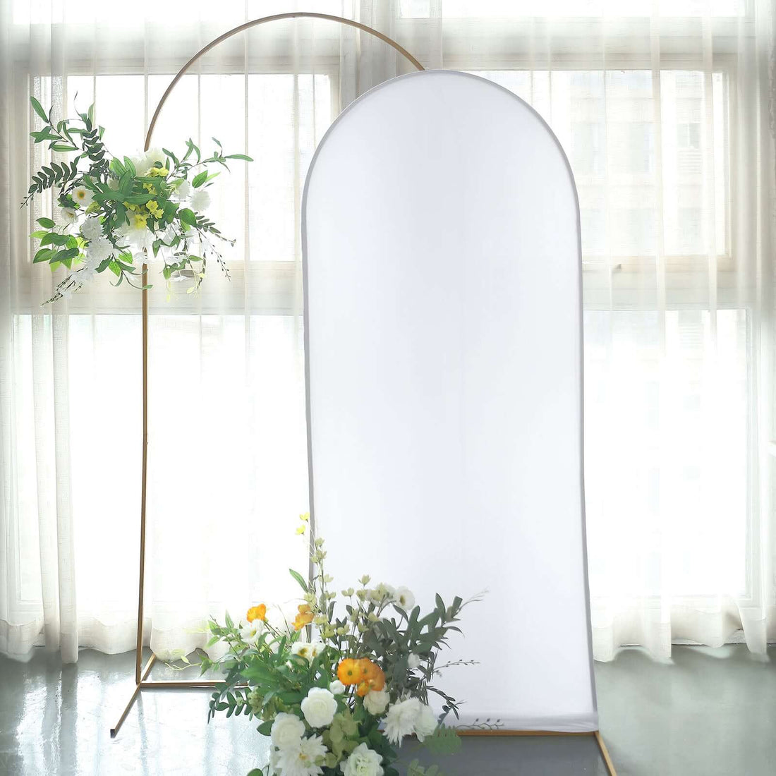 Studio backdrop with floral arrangement and gold stand