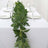 Artificial green leaf garland for table decoration with glassware