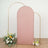 Rose gold glitter backdrop with gold arch and floral arrangement.