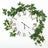 Wall clock adorned with greenery and white flowers