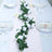 White floral table runner on an elegantly set dining table.
