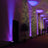 Colorful lighting effects on a wall in an indoor venue.