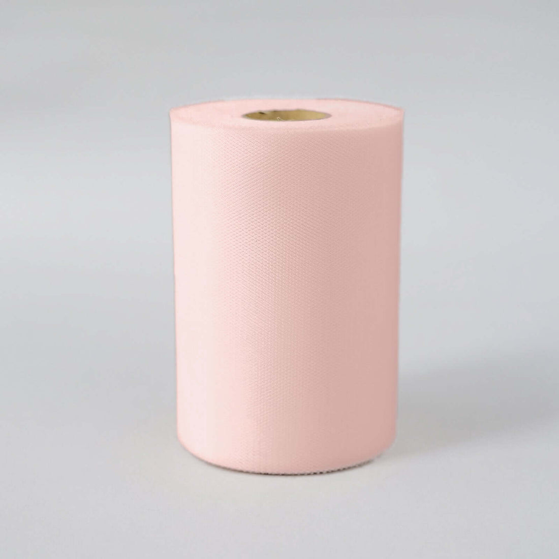 Pink fabric roll on a plain background