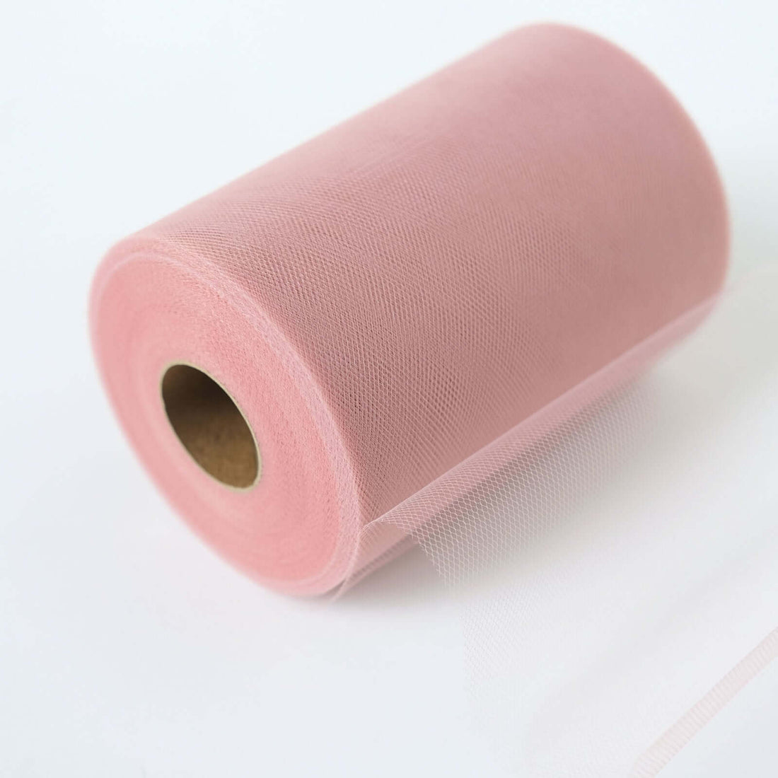 Pink tulle roll on a white background for crafting and decorations.