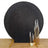 Black textured backdrop with gold candle holders and candles for photography.