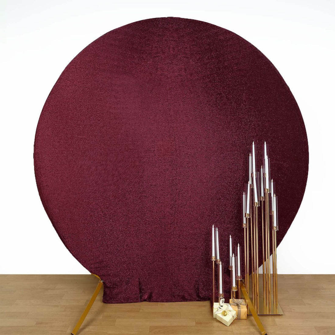 Burgundy sequin backdrop with gold candle holders for events