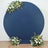Navy blue circle backdrop with floral arrangements on both sides.