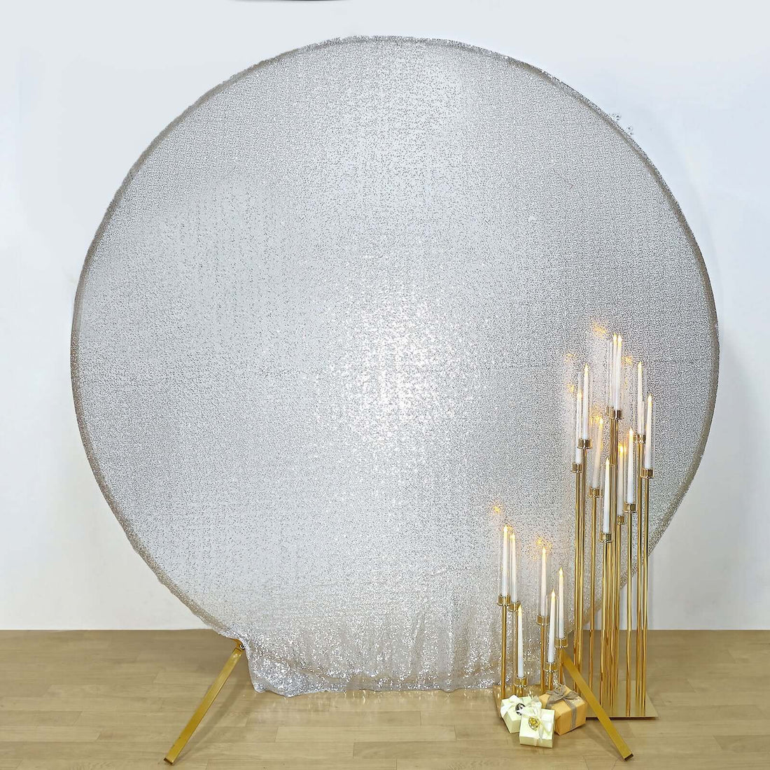 Silver reflective backdrop with gold candle holders and candles